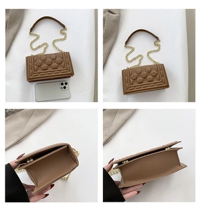 Detail view of brown quilted handbag with dual interior compartments and golden chain strap