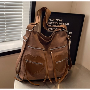 Close-up of vintage corduroy backpack with unique heart-shaped pockets and tassel zippers