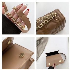 Detail of brown quilted leather handbag featuring dual magnetic buckles and chain strap