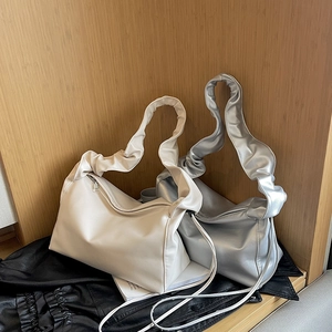 Elegant pleated baguette shoulder bag in cream white and metallic silver soft leather