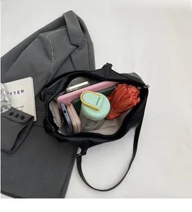 Detailed interior of large black tote bag showing spacious compartments and storage