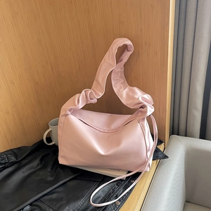 Pink scrunchie strap baguette bag with soft pleated design and crossbody strap