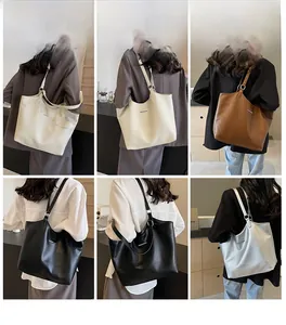 Detail view of the large commuter tote bag showing soft lychee grain leather texture