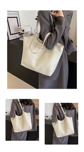 Close-up of cream faux leather tote bag showing lychee grain texture and silver metal trim