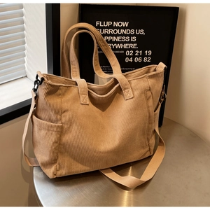 Macro view of khaki corduroy tote bag showing side pocket and durable wide shoulder strap