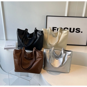 Detailed view of large tote bags in black, coffee, white, and silver textured leather
