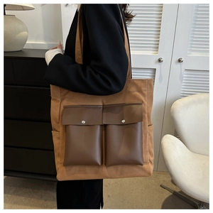 Fashionable khaki canvas tote bag with brown PU pockets shown in a minimalist room