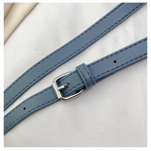 Detail of adjustable blue PU leather shoulder strap with silver buckle and fine stitching