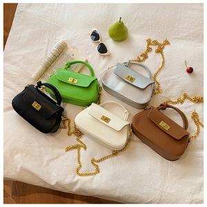 Selection of colorful crossbody bags with gold hardware and knotted top handles