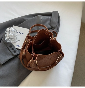 Interior view of caramel bucket bag showing spacious compartments and quilting