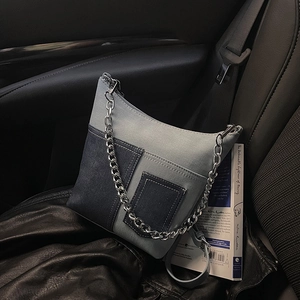 Vintage patchwork denim bucket bag with metal chain strap and adjustable leather shoulder strap