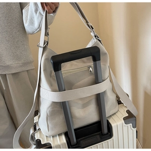 Detail view of corduroy backpack with back trolley sleeve for luggage attachment