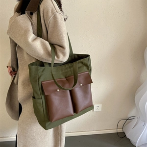 Minimalist deep army green canvas tote bag with brown faux leather front pockets