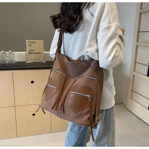 Detail of vintage brown corduroy backpack with heart shaped pockets on a female model