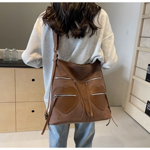 Rear view of model wearing a brown vintage corduroy backpack with leather accents