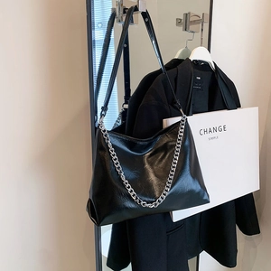 Minimalist black oil wax leather hobo bag with silver chain strap for casual commute