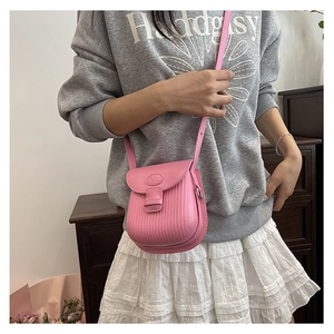 Pink PU leather crossbody bag with vertical striped texture shown on a female model
