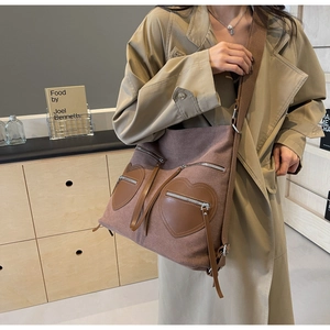 Detail of vintage corduroy backpack with brown leather heart-shaped pockets and zips