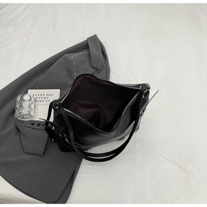 Top view of large black leather tote bag showing spacious interior with brown lining