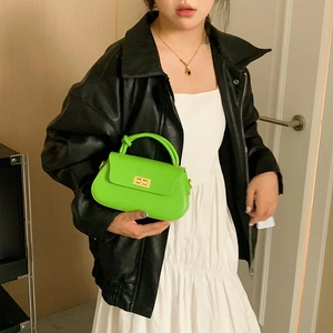 Bright green faux leather handbag with decorative knot handle and gold twist lock clasp