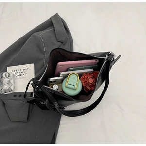 Top-down view of a spacious black tote bag showing its large interior capacity for daily items