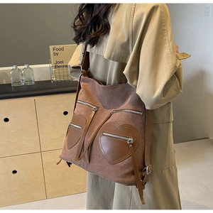 Detailed view of caramel corduroy backpack featuring unique heart shaped front pockets