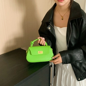 Neon green faux leather crossbody bag with knot handle and golden turn-lock closure