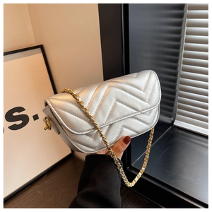 Detail of silver chevron quilted chain bag with metallic finish and V-shaped stitching
