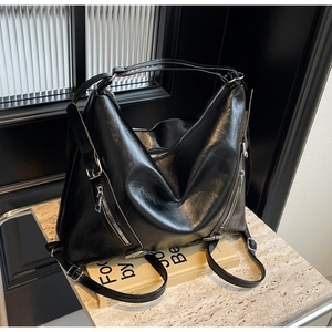 Close-up of black oil-wax PU leather tote bag featuring silver zipper details