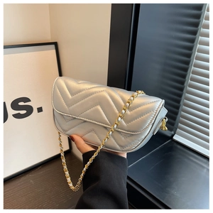 Detail of silver chevron quilted flap bag with adjustable mixed metal chain strap