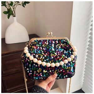 Detail of colorful sequins and pearl handle on a luxury shell evening bag