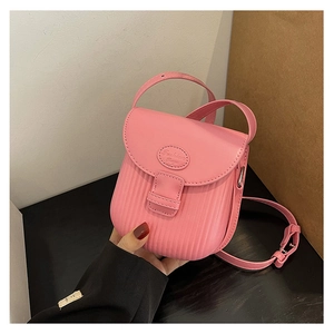 Detail of pink PU crossbody bag featuring a vertical pleated texture and fashion logo