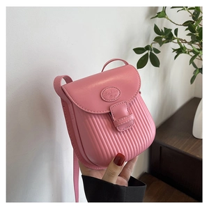 Close-up of pink crossbody bag with vertical striped texture and fashion logo