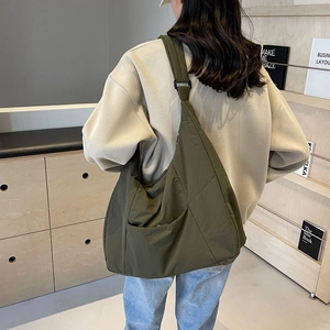 Olive green nylon oversized tote bag with adjustable strap and side pocket for casual wear