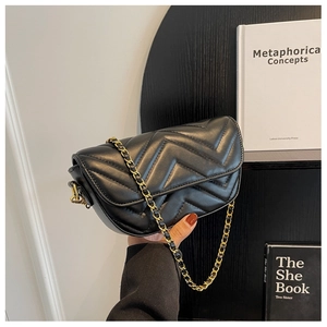 Close-up of black PU leather crossbody bag with elegant V-shaped quilting and gold chain strap