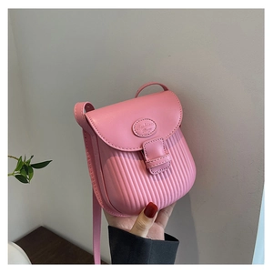 Close-up of bright pink mini crossbody bag with pleated texture and Fashion Bag logo