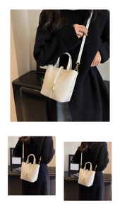 Detail of white lychee leather bucket bag featuring a gold lock and versatile straps