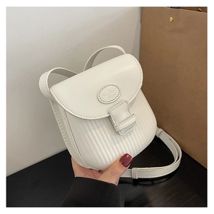Detail showing the white crossbody bag with pleated texture and Fashion Bags logo plate