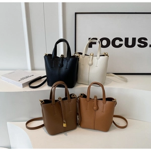 Detailed view of bucket bags in four classic colors with lychee grain leather texture
