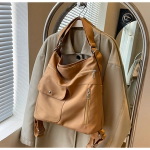 Detail of khaki large capacity multi-pocket nylon shoulder bag with metal zipper accents