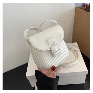 Detail of white PU leather mini crossbody bag featuring vertical pleated texture and metal logo
