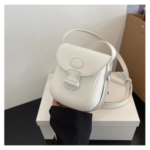 Detail of white PU leather crossbody bag with vertical texture and Fashion Bags logo plaque