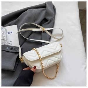 Close-up of white V-quilted faux leather crossbody bag with elegant gold chain strap