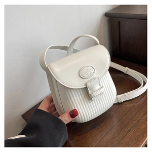 Detail of a creamy white mini crossbody bag with vertical pleated texture and metal logo