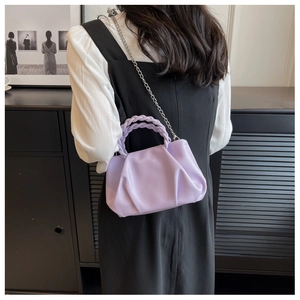 Detail of lavender pleated cloud bag with woven handle and silver chain strap for women