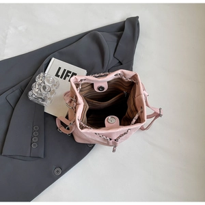 Top view of pink leather bucket bag showing striped lining and silver magnetic clasp