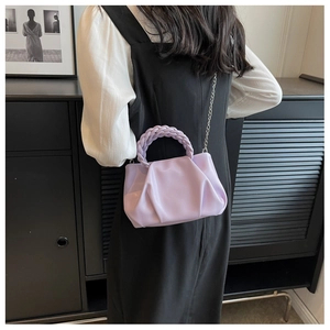 Detail of light purple pleated cloud bag with woven handle and silver metal chain strap