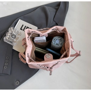 Detailed interior of pink bucket bag showing large capacity and magnetic closure