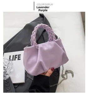 Detail of taro purple pleated handbag with woven handle and silver chain strap