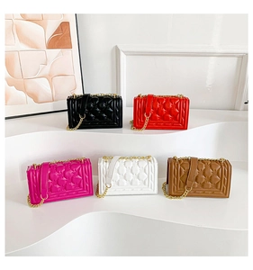Quilted chain handbags in five colors displayed on white pedestals for a stylish look